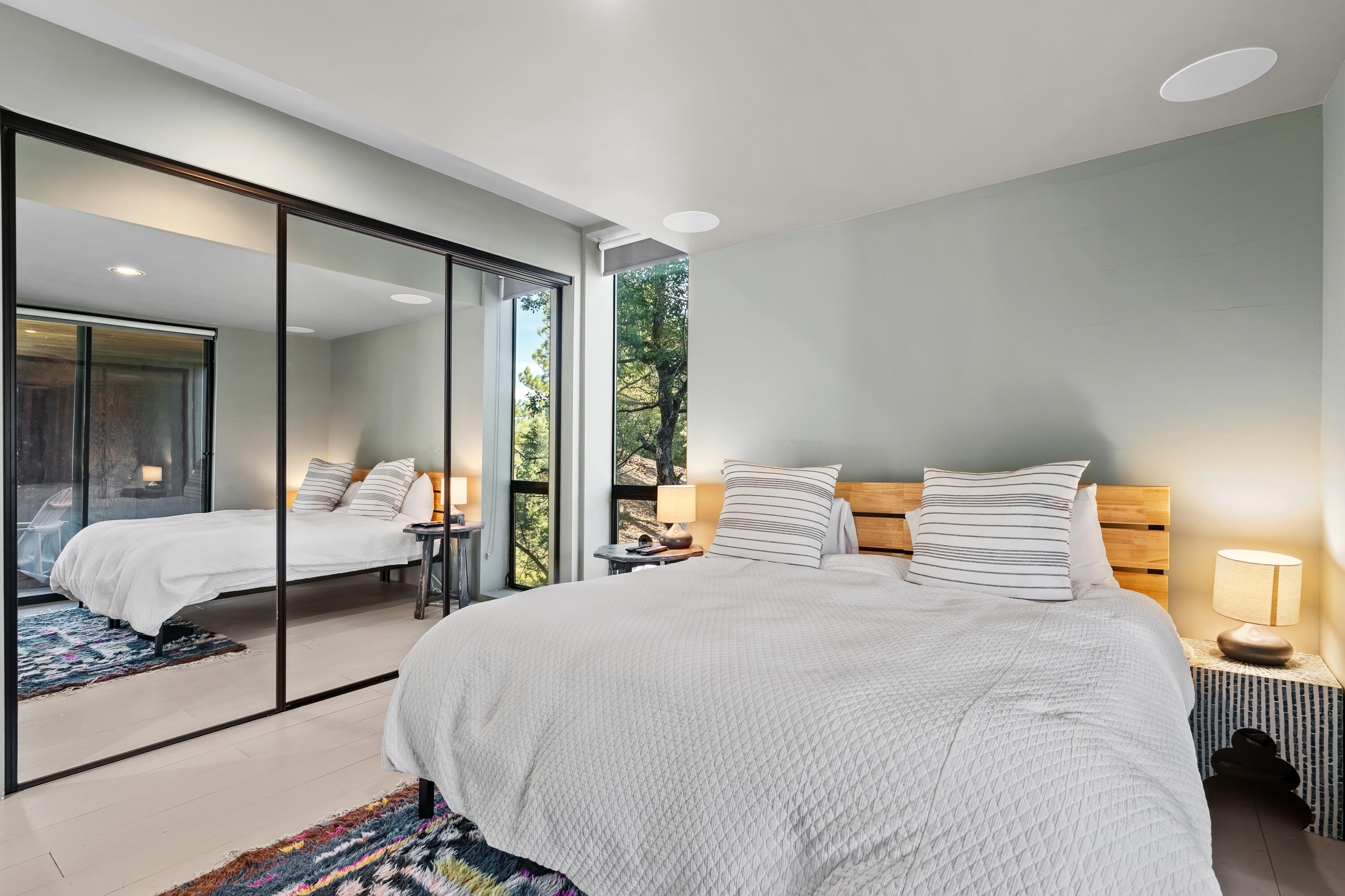 54685 Crest Drive Idyllwild, CA 92549 - Photo 30 of 50 a bedroom with a large bed and a large mirror