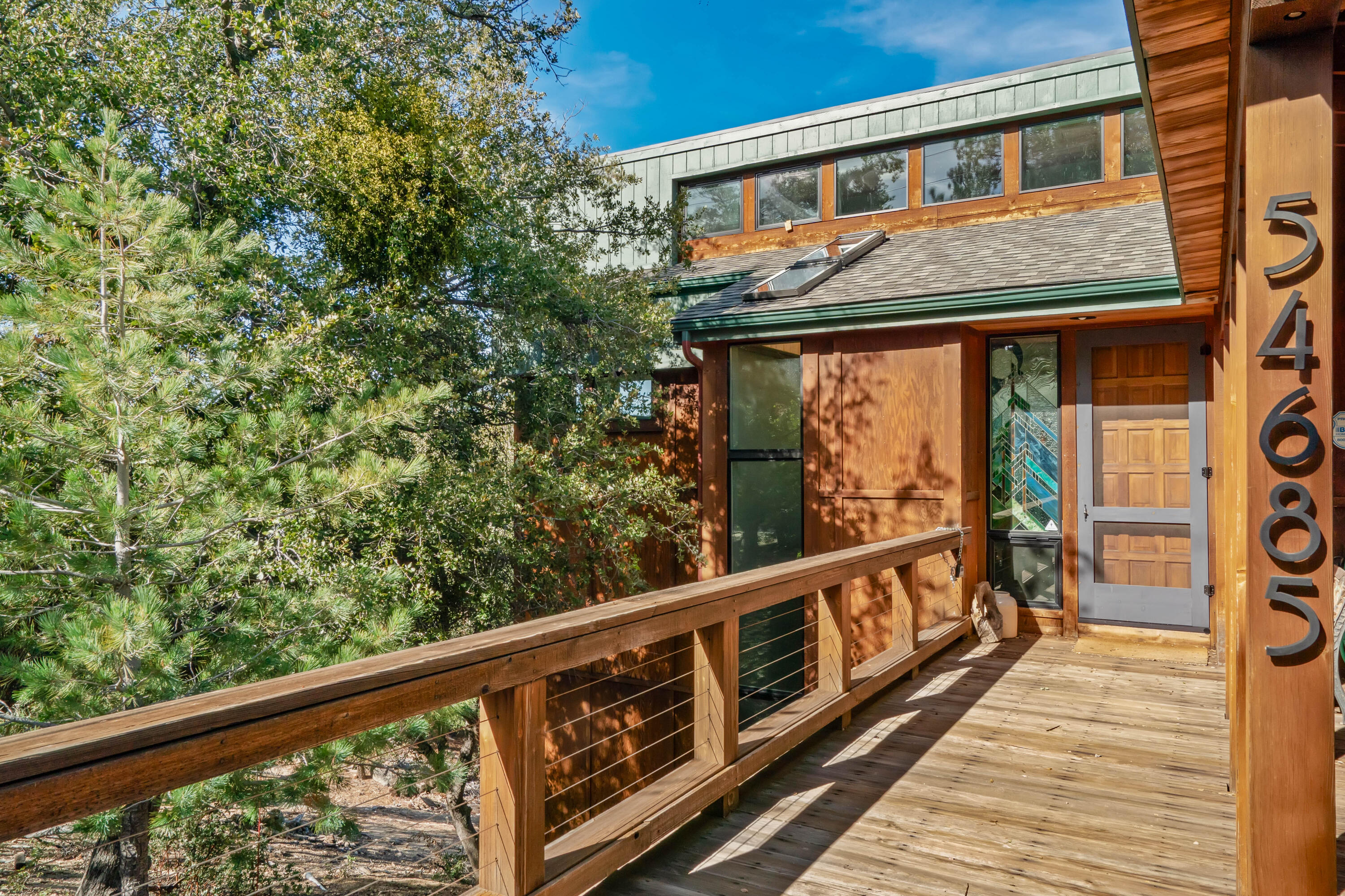 54685 Crest Drive Idyllwild, CA 92549 - Photo 3 of 50 a view of a balcony with wooden floor and fence