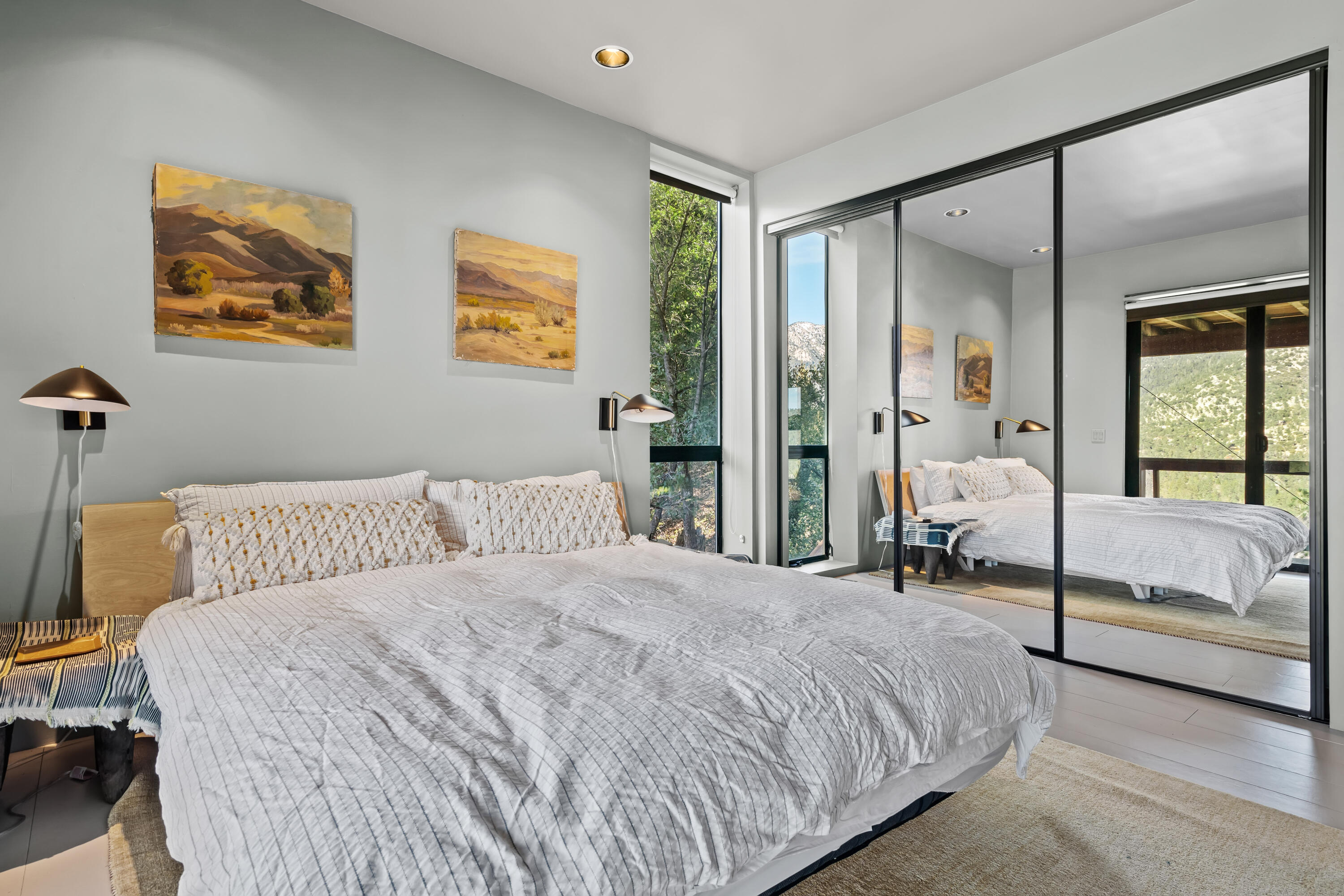 54685 Crest Drive Idyllwild, CA 92549 - Photo 36 of 50 a bedroom with a bed and a large mirror