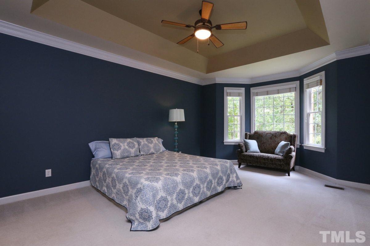2621 Lizei Street Raleigh, NC 27616 - Photo 12 of 25 a bedroom with a bed and glass window