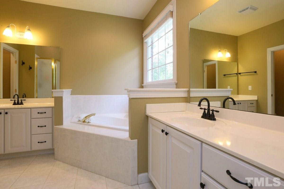 2621 Lizei Street Raleigh, NC 27616 - Photo 14 of 25 a bathroom with a sink double vanity and a mirror