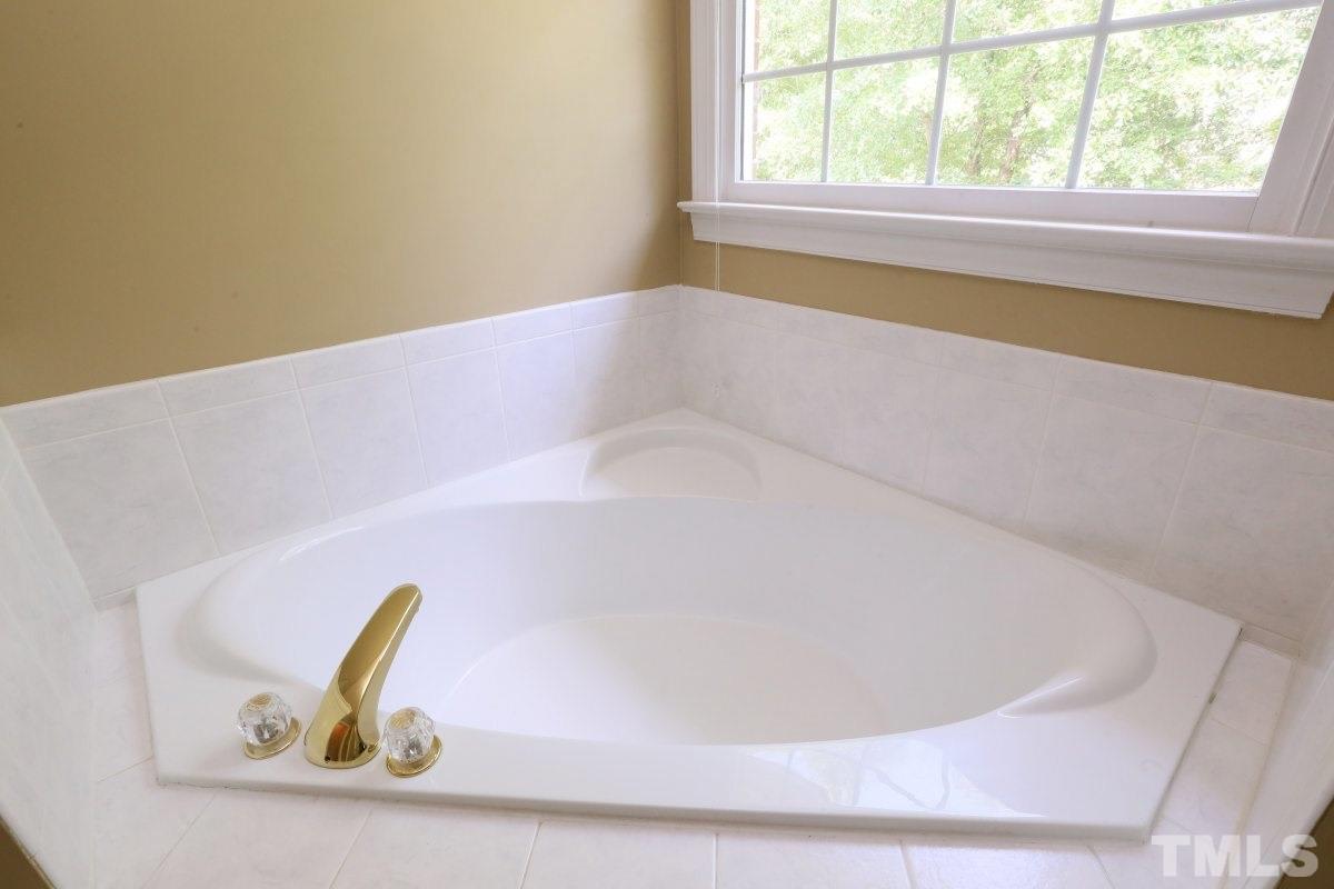 2621 Lizei Street Raleigh, NC 27616 - Photo 15 of 25 a bath tub sitting in a bathroom