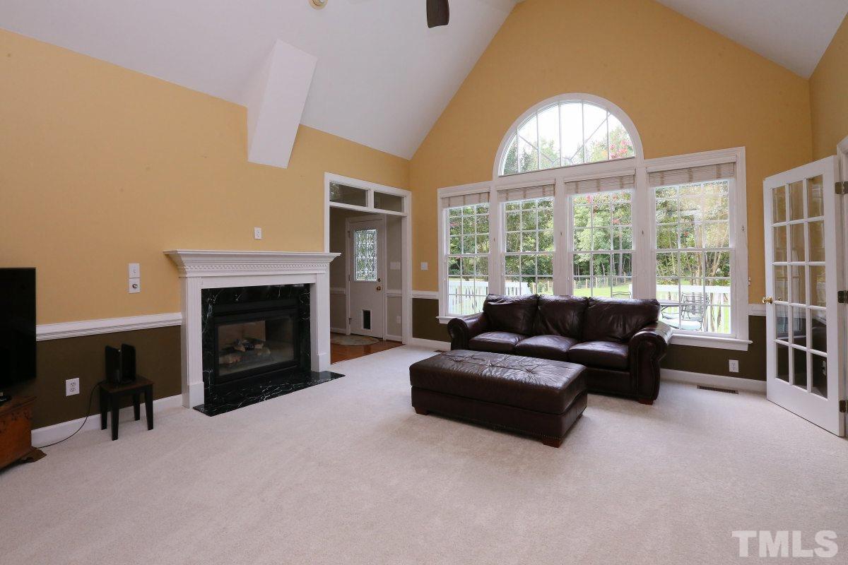 2621 Lizei Street Raleigh, NC 27616 - Photo 18 of 25 a living room with furniture a fireplace and a large window