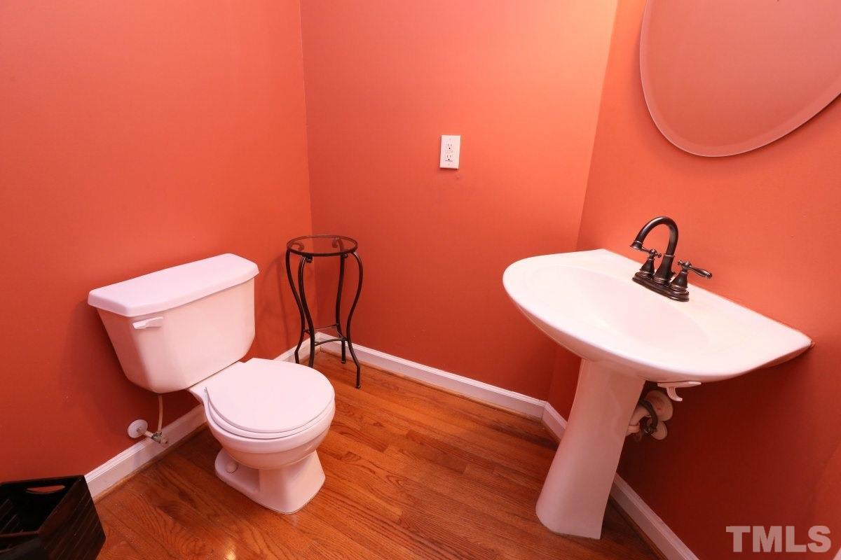 2621 Lizei Street Raleigh, NC 27616 - Photo 20 of 25 a bathroom with a toilet sink and mirror
