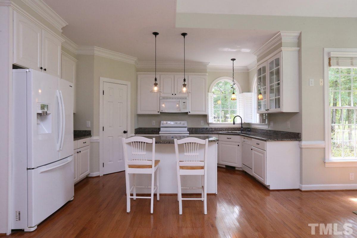 2621 Lizei Street Raleigh, NC 27616 - Photo 6 of 25 a kitchen with white cabinets and refrigerator