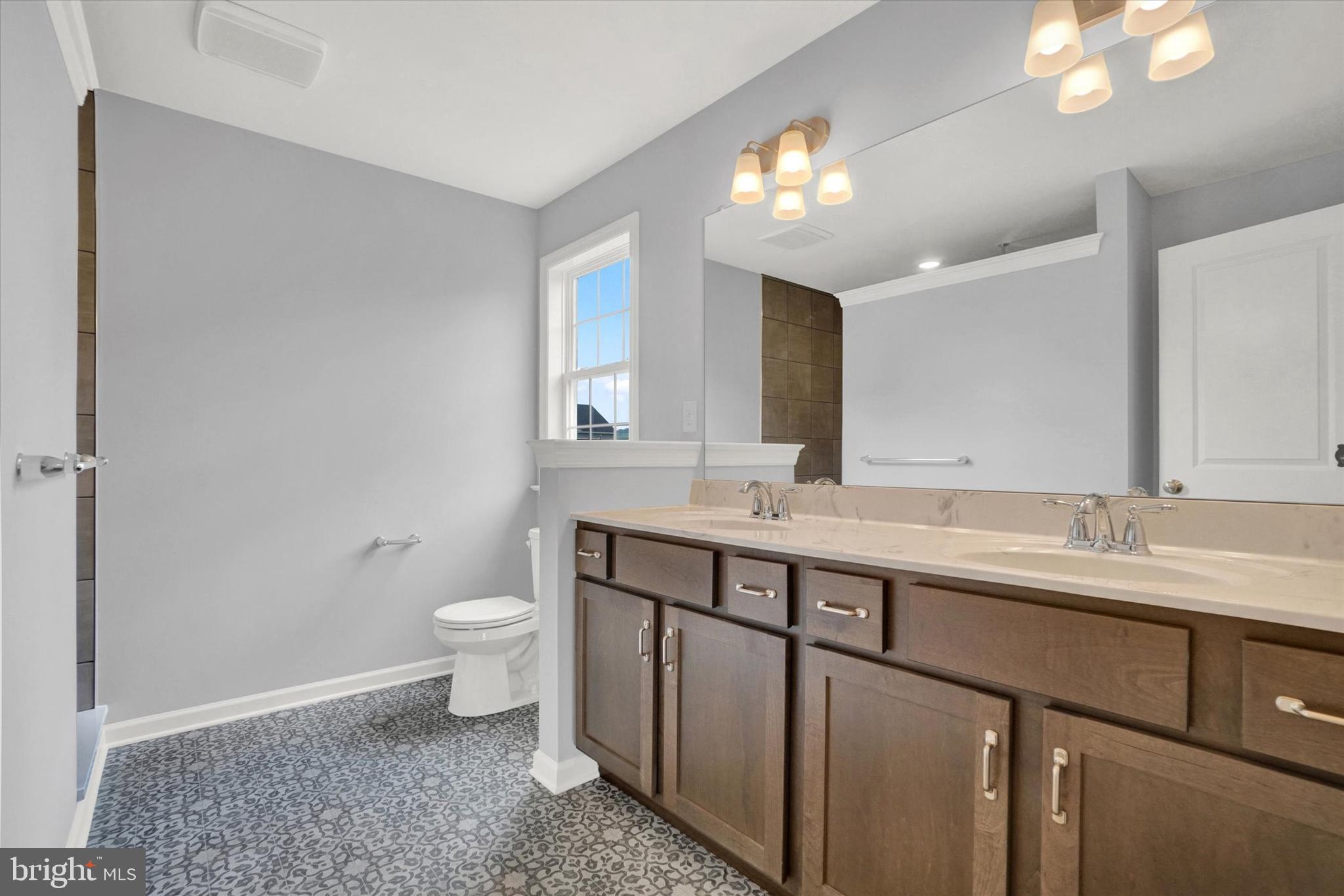 602 Rishel Drive York, PA 17406 - Photo 20 of 30 a spacious bathroom with a double vanity sink toilet and a mirror