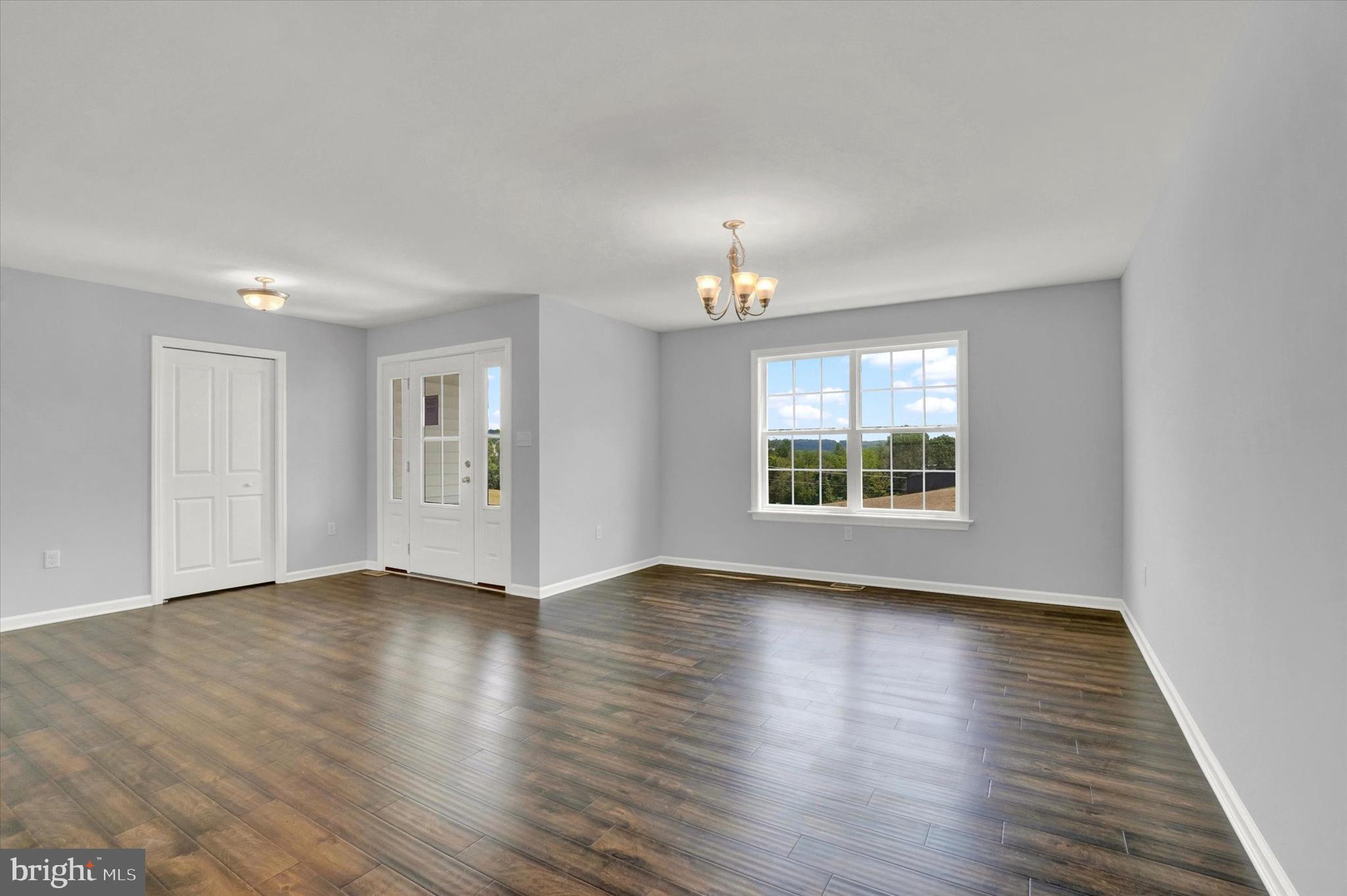602 Rishel Drive York, PA 17406 - Photo 2 of 30 a view of an empty room with wooden floor and a window