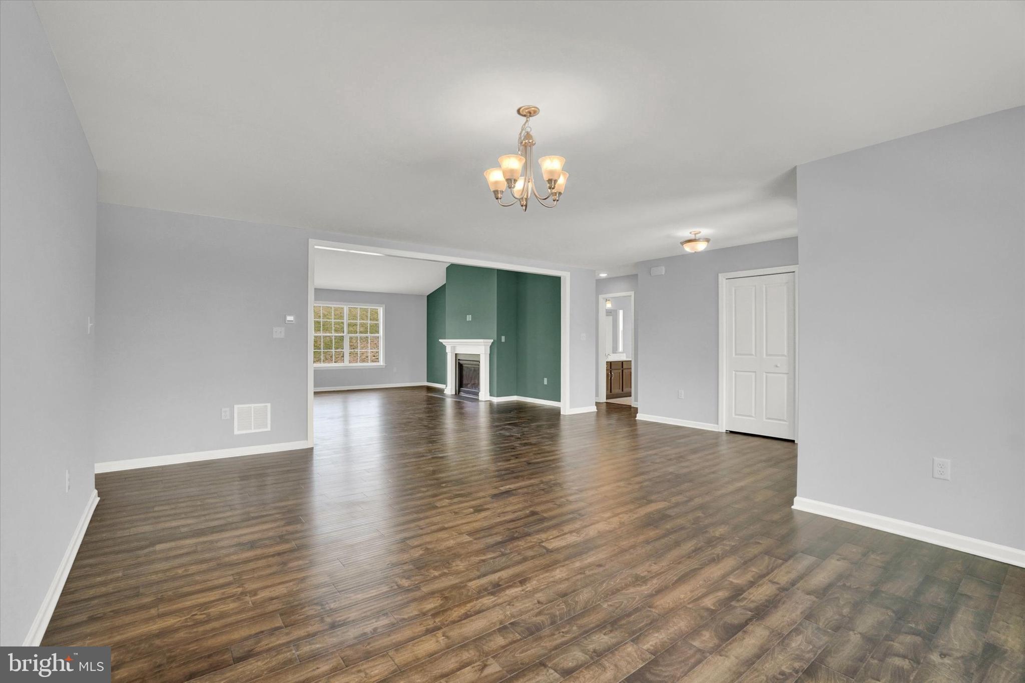 602 Rishel Drive York, PA 17406 - Photo 5 of 30 an empty room with wooden floor chandelier and windows