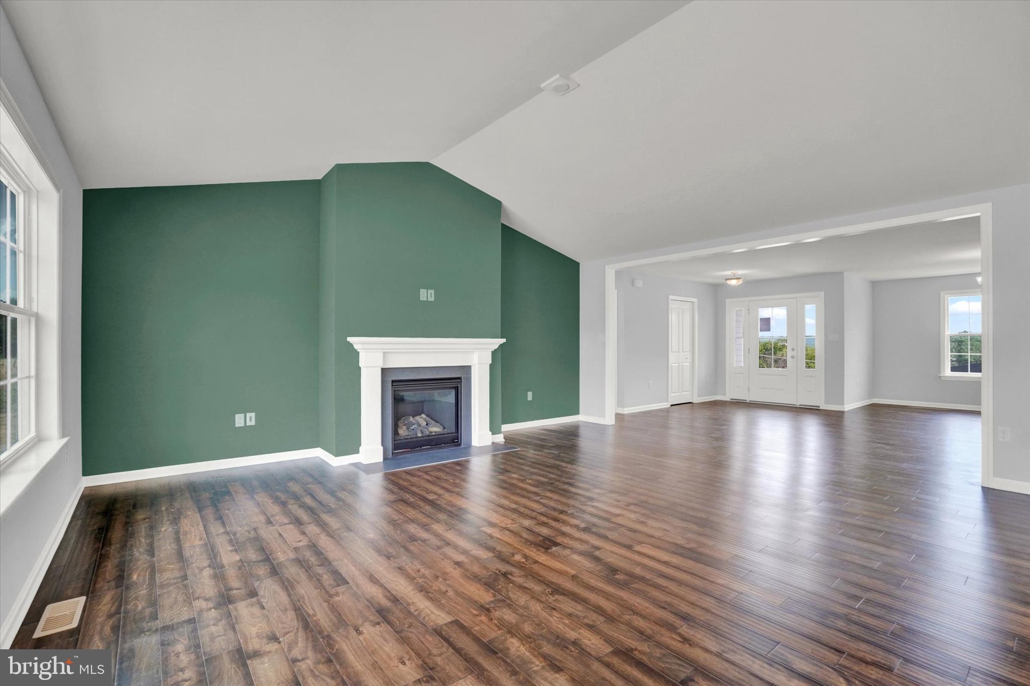 602 Rishel Drive York, PA 17406 - Photo 7 of 30 an empty room with wooden floor fireplace and windows