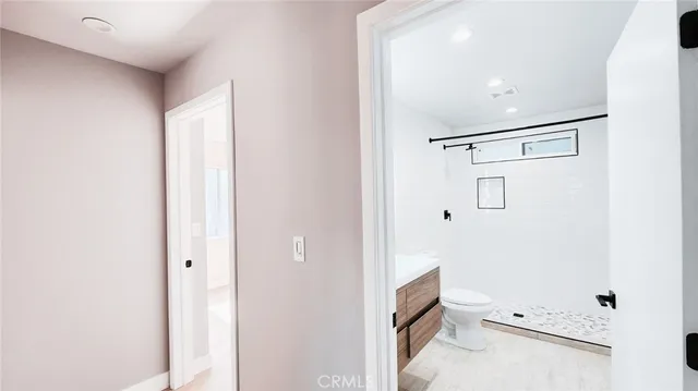 a bathroom with a toilet and a shower