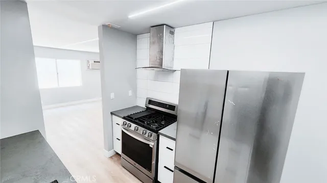 a kitchen with a refrigerator and a stove