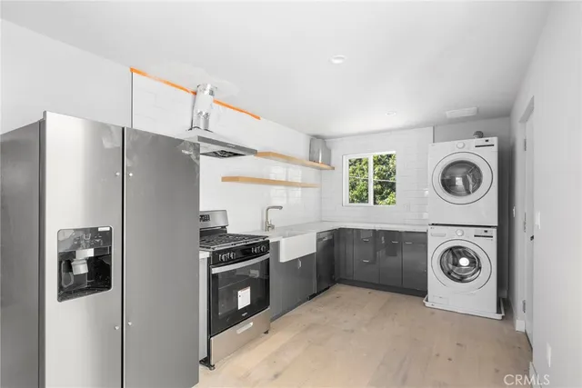 a kitchen with a refrigerator and a stove top oven
