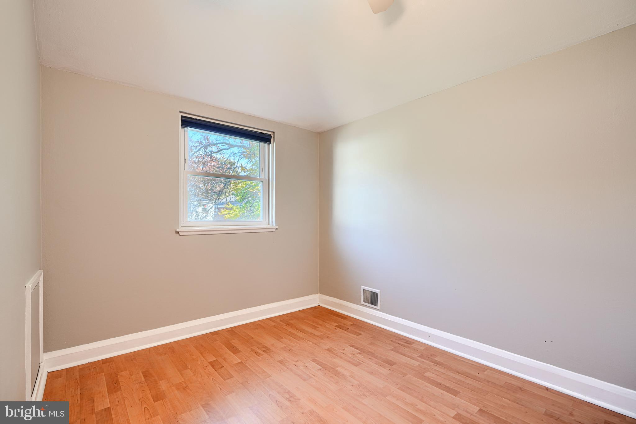 1620 Naturo Road Towson, MD 21286 - Photo 13 of 43 a view of an empty room with wooden floor and a window