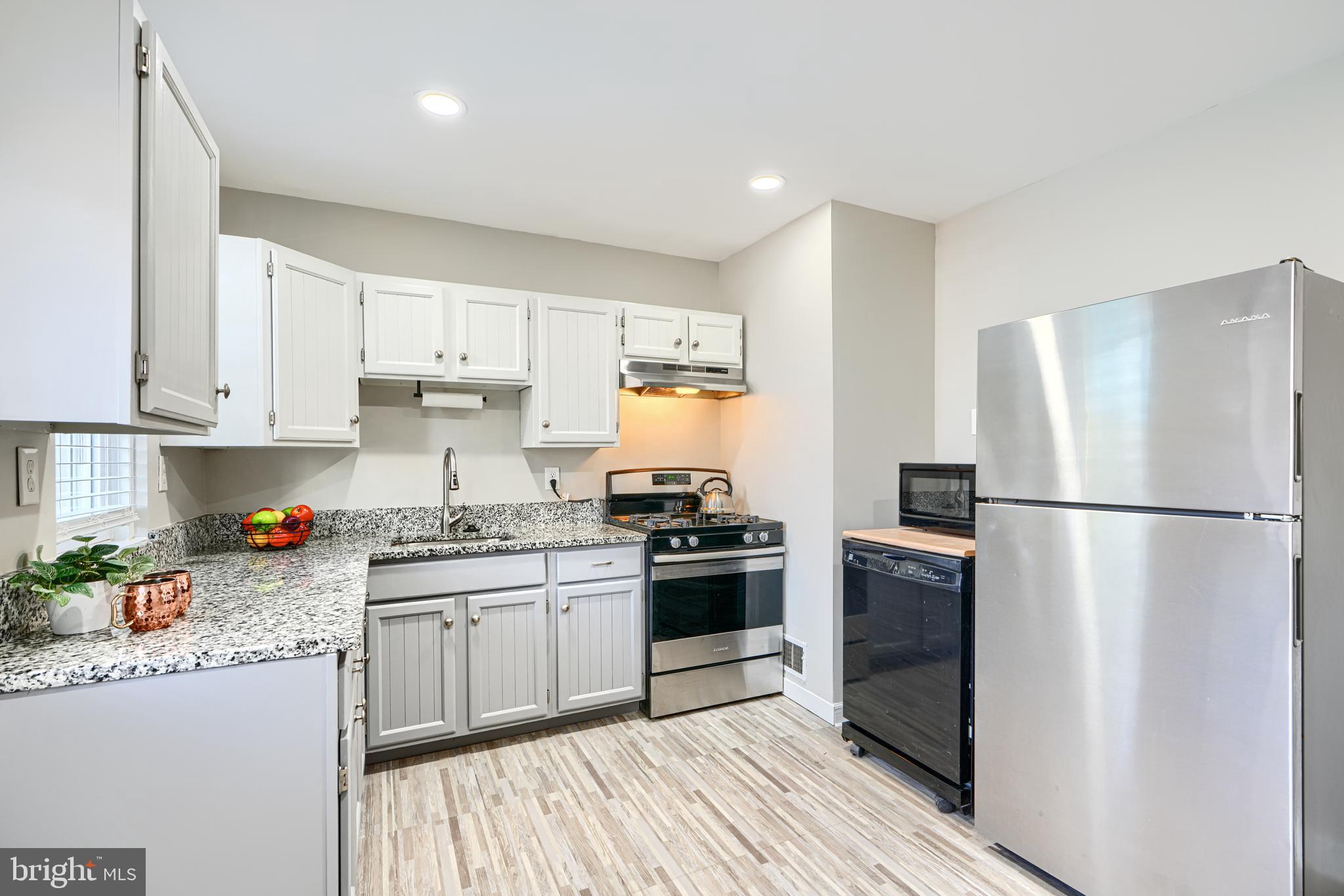 1620 Naturo Road Towson, MD 21286 - Photo 5 of 43 a kitchen with a white cabinets and white appliances