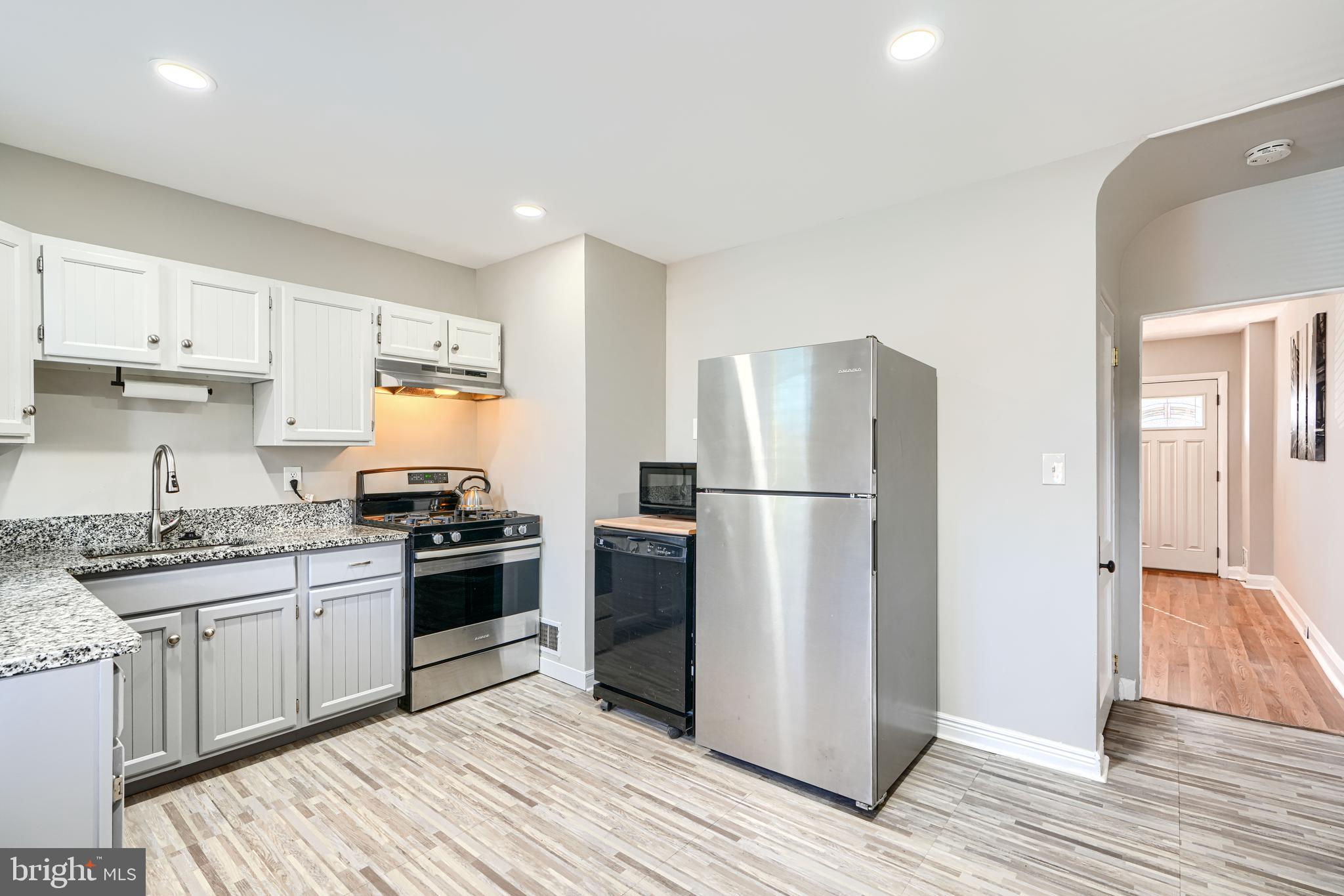 1620 Naturo Road Towson, MD 21286 - Photo 6 of 43 a kitchen with a sink a refrigerator and a stove top oven