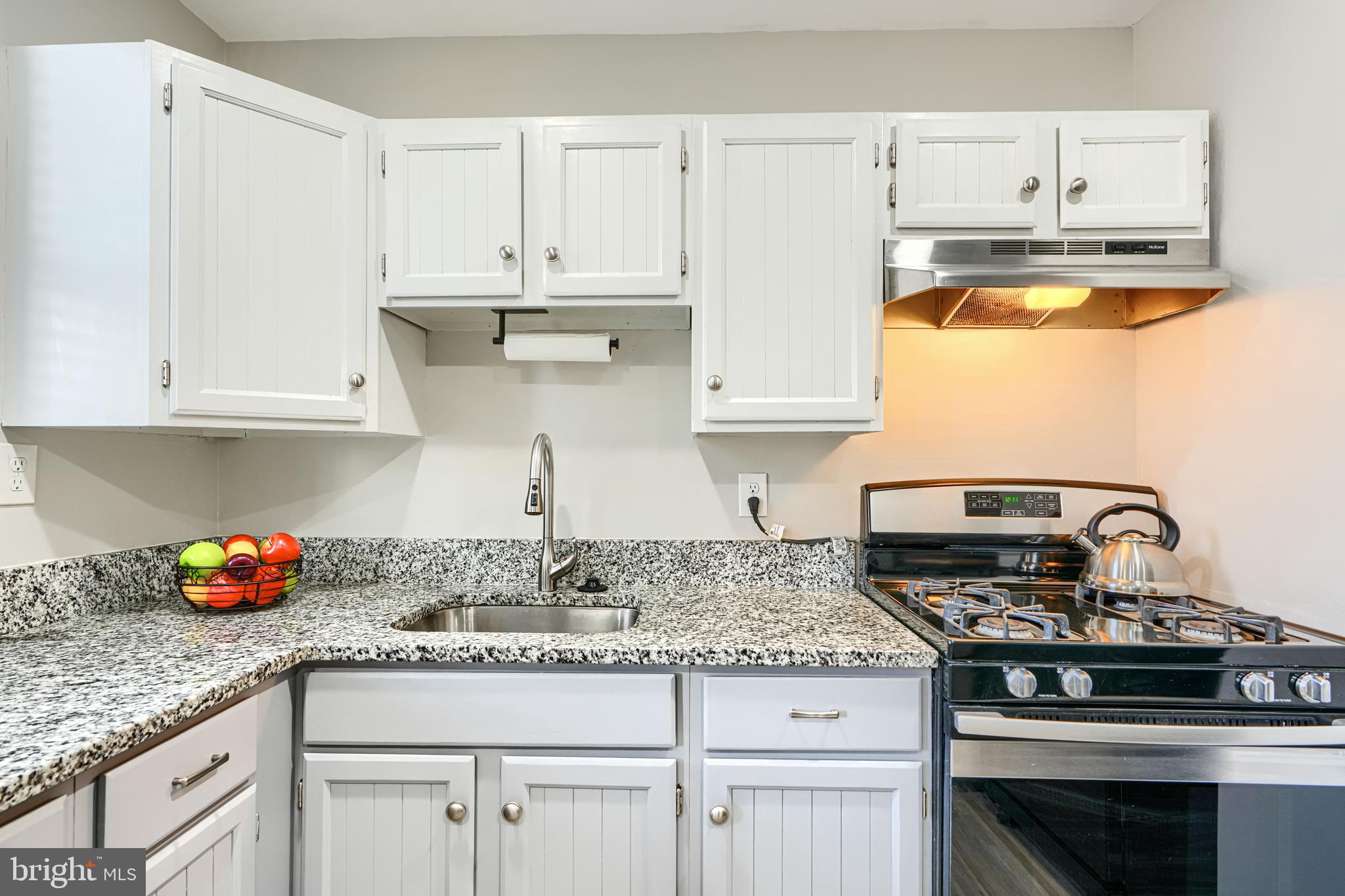 1620 Naturo Road Towson, MD 21286 - Photo 7 of 43 a kitchen with granite countertop white cabinets and appliances