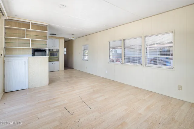 an empty room with a cabinet and mirrors