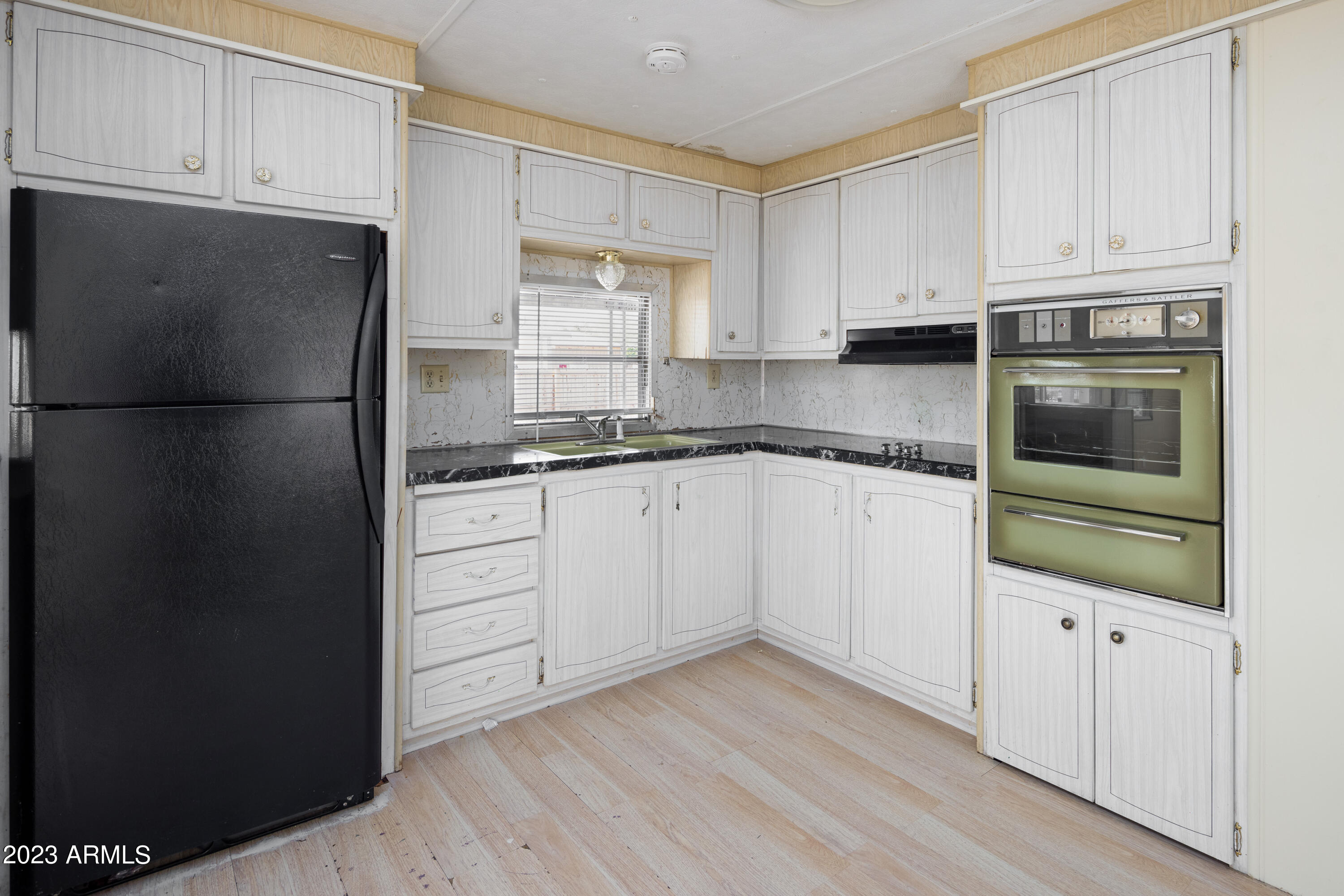9618 East Aspen Circle Mesa, AZ 85208 - Photo 14 of 30 a kitchen with granite countertop white cabinets and refrigerator
