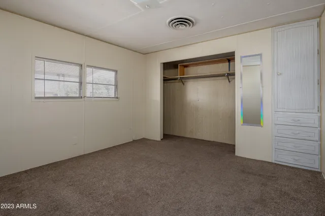 a bathroom with a granite countertop sink a mirror a bathtub and shower