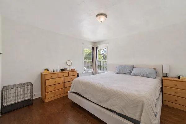 a bedroom with a bed and a window