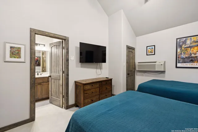 a bedroom with a bed and a flat screen tv