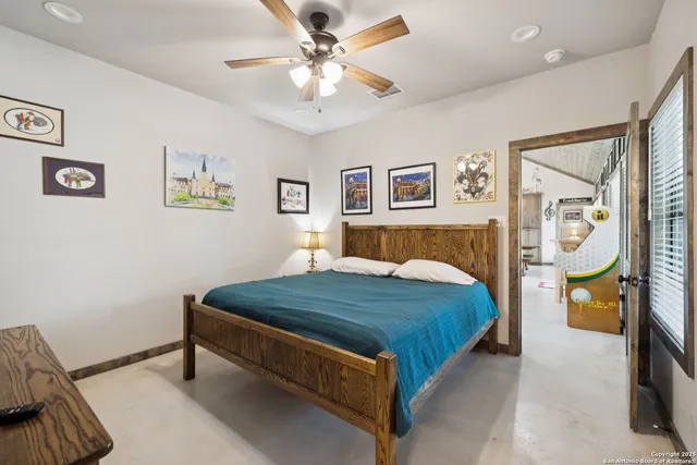 a bed sitting in a bedroom and painting on the wall