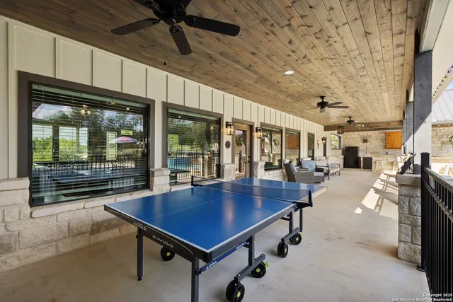 a dining room with furniture and a floor to ceiling window
