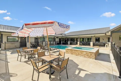 a view of a house with swimming pool and sitting area