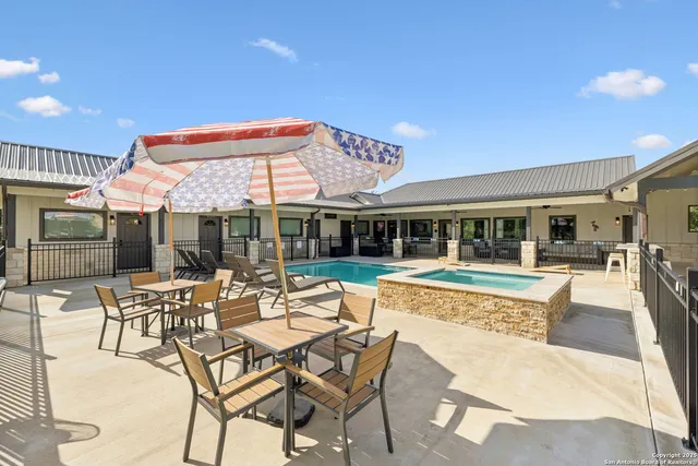 a view of a house with swimming pool and sitting area