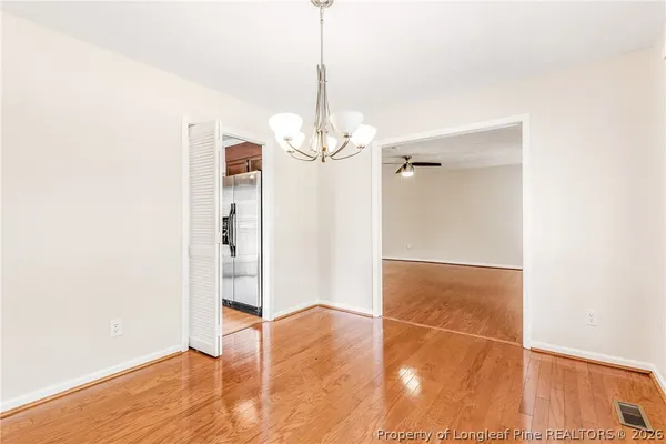 a view of a room with wooden floor and white walls