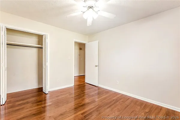 a view of an empty room with wooden floor