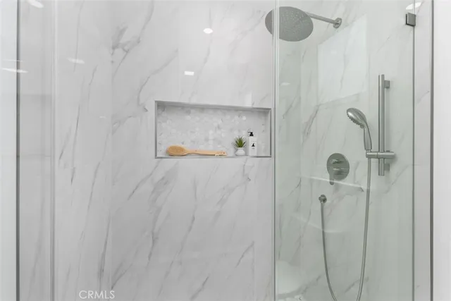 a bathroom with a shower a toilet and sink