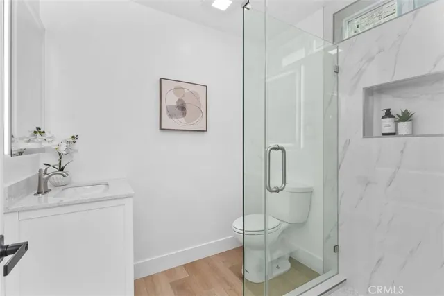 a bathroom with a shower a mirror and a sink