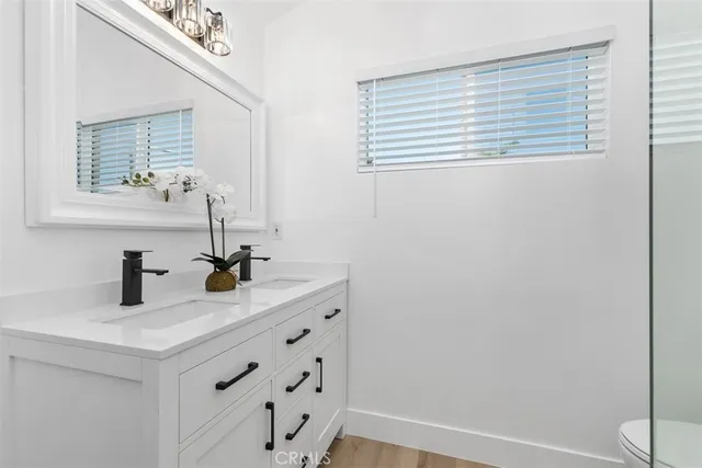 a bedroom with a bed and painting on the wall