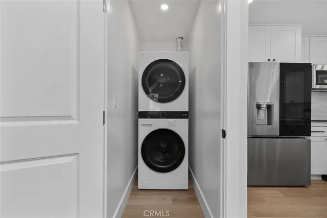 a view of swimming pool that has lawn chairs with plants and trees