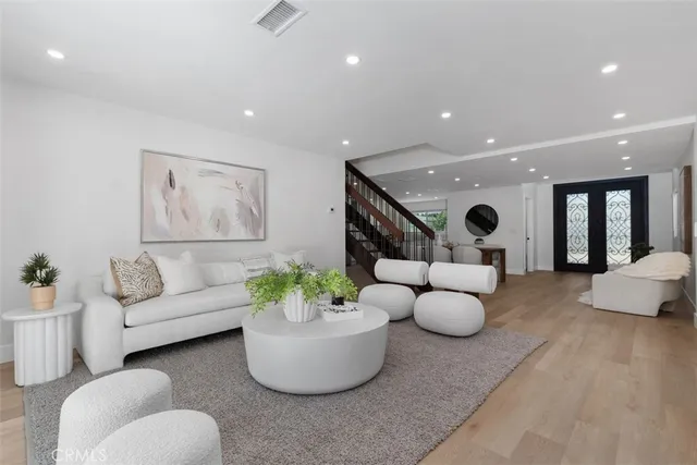a kitchen with a sink dishwasher stove and white cabinets