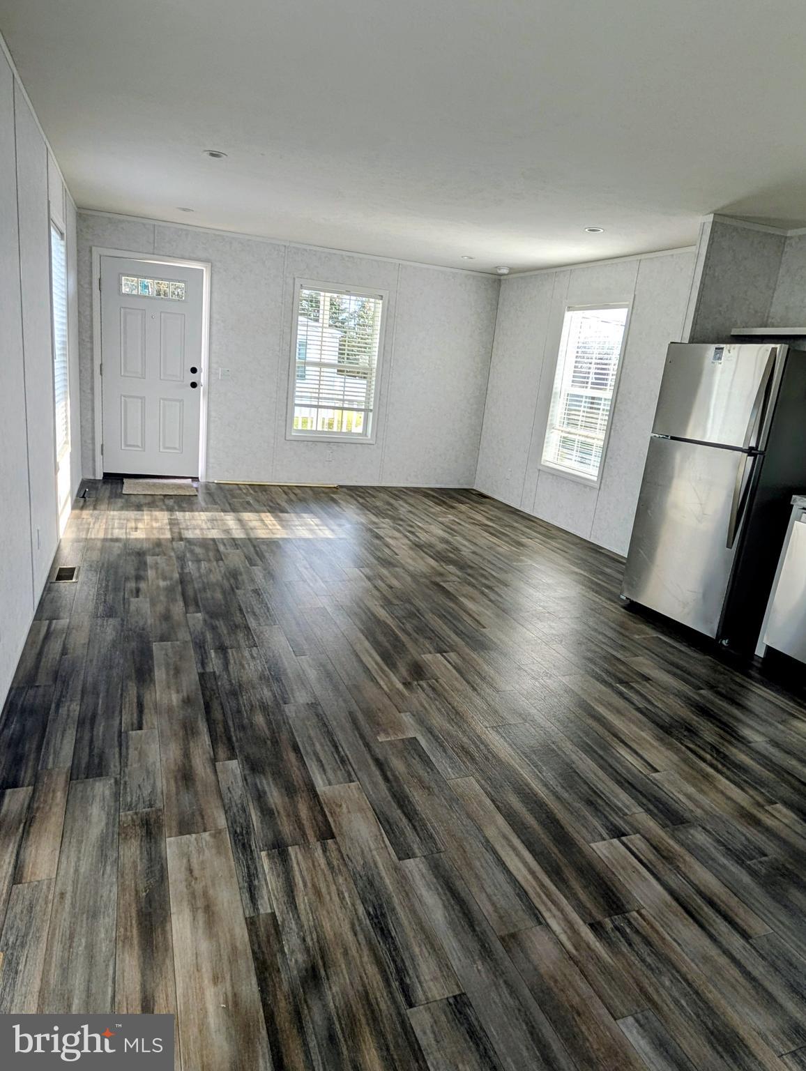 16 Abbey Road Coatesville, PA 19320 - Photo 2 of 8 a view of an empty room with wooden floor and a window