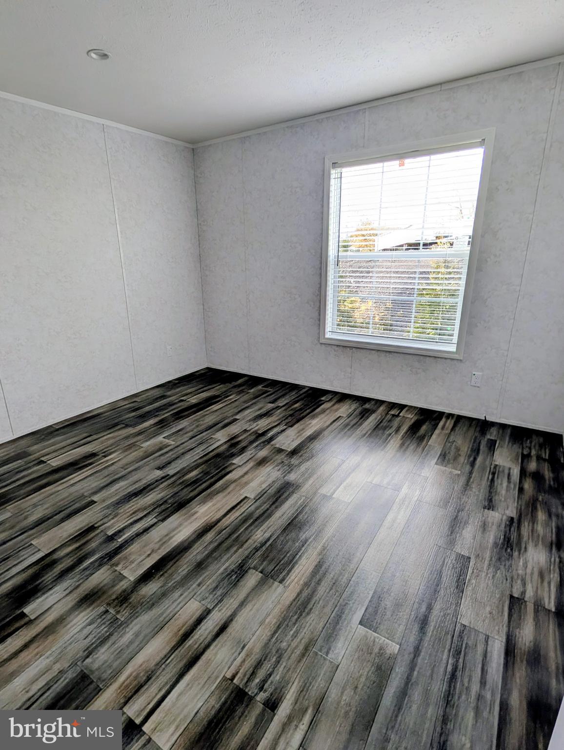 16 Abbey Road Coatesville, PA 19320 - Photo 5 of 8 a view of an empty room with wooden floor and a window