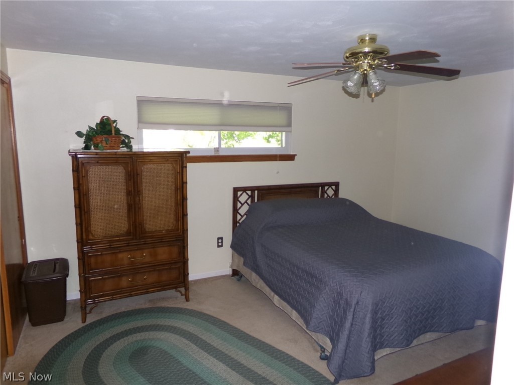 1912 Pickle Road Akron, OH 44312 - Photo 13 of 26 Bedroom featuring carpet and ceiling fan