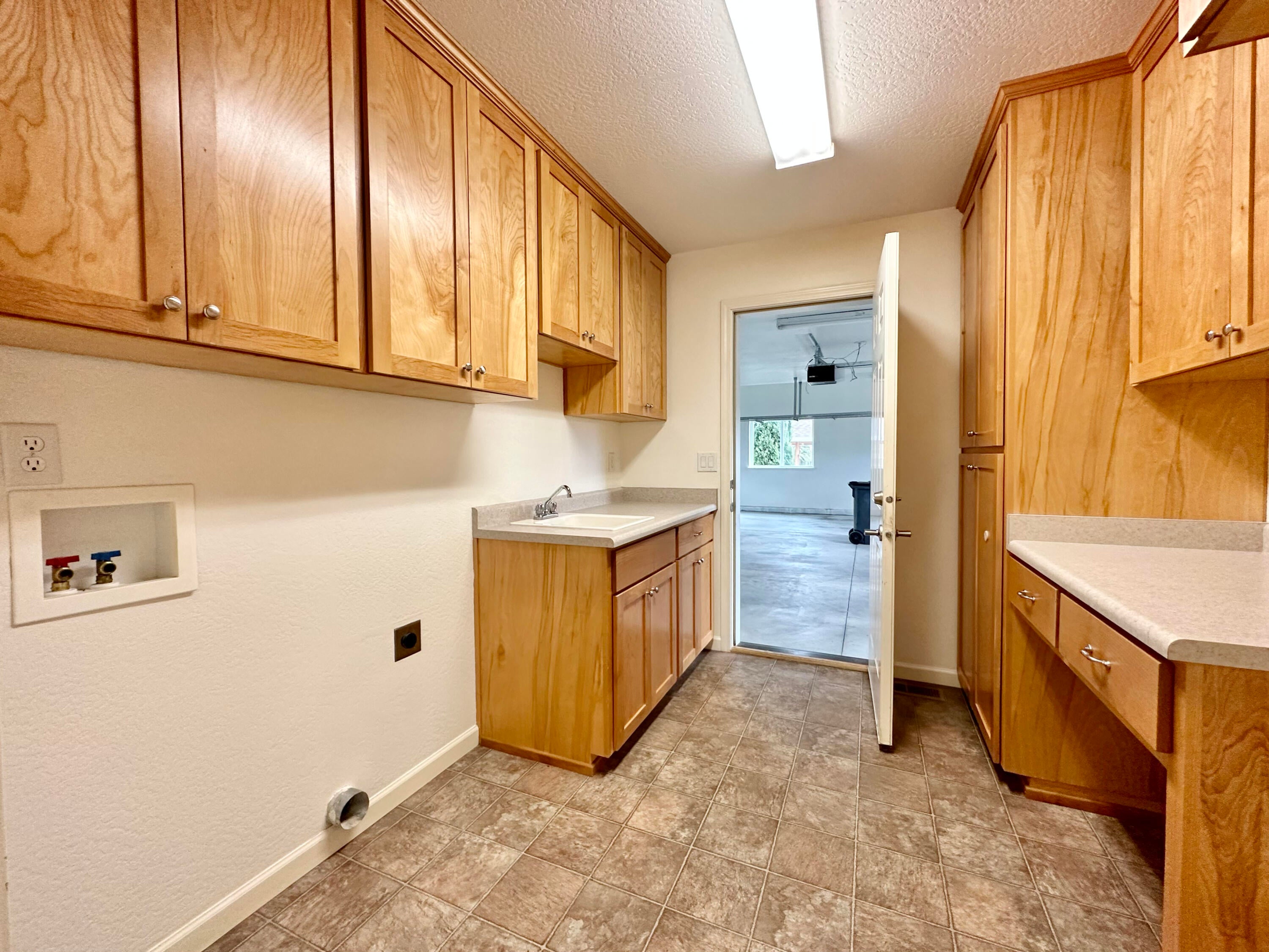 112 Walnut Place Phoenix, OR 97535 - Photo 24 of 78 Large laundry rm, plus sink, desk and ironing board