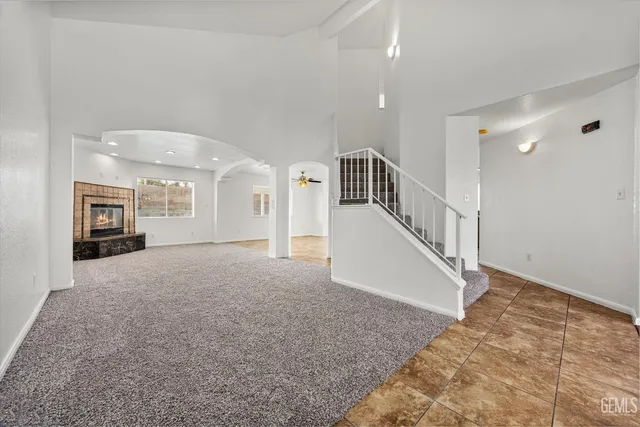 a living room with a fireplace a flat screen tv and a floor