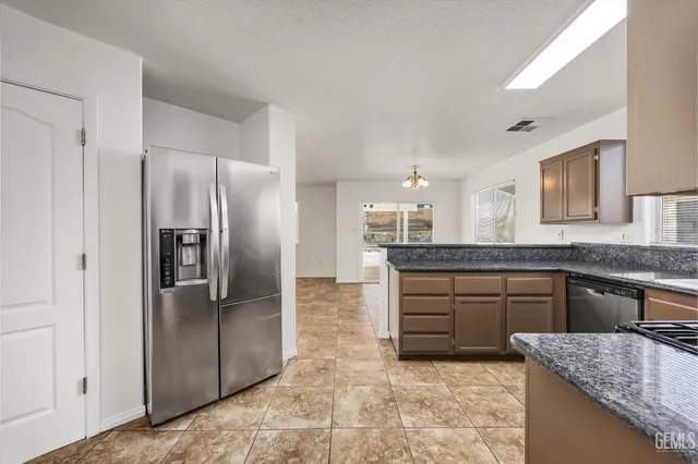 an empty room with closet and a chandelier fan