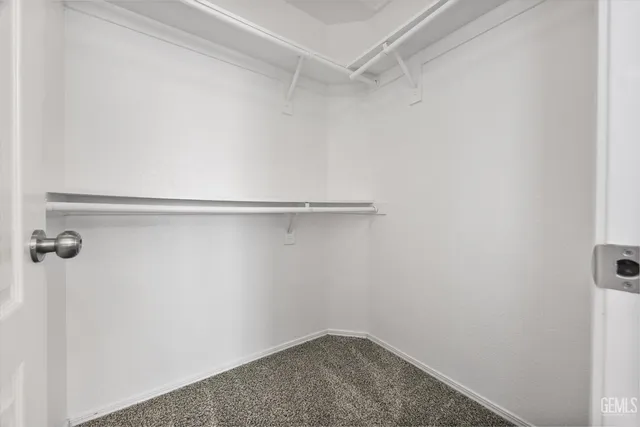 a bathroom with a granite countertop sink a toilet and a large mirror