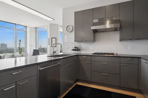 a kitchen with stainless steel appliances granite countertop a sink and cabinets