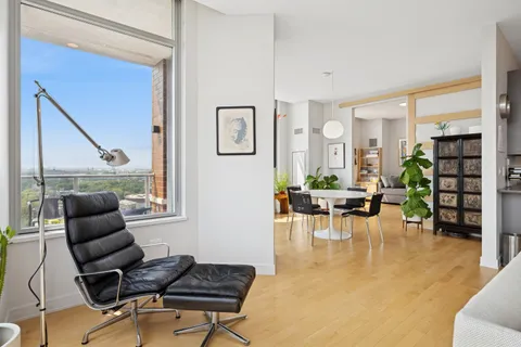 a living room with furniture a rug and a window