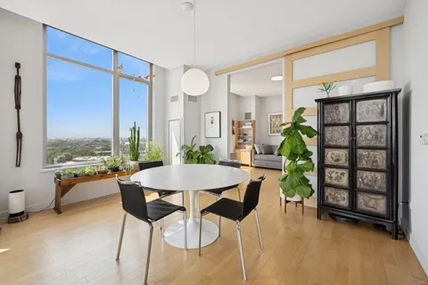 a view of a dining room with furniture and a window