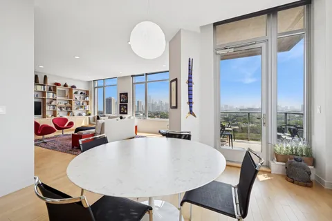 a living room with dining room and wooden floor