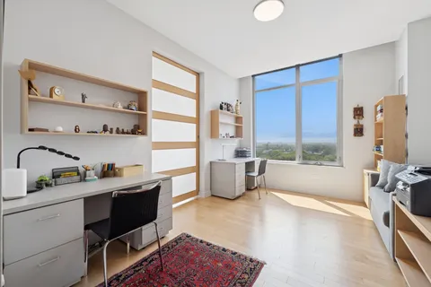 a kitchen with stainless steel appliances granite countertop a sink dishwasher stove and cabinets with wooden floor