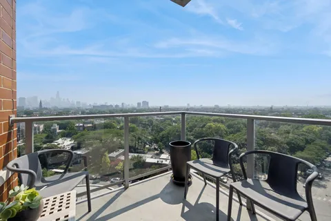 a view of a terrace with couches and a potted plant on a table