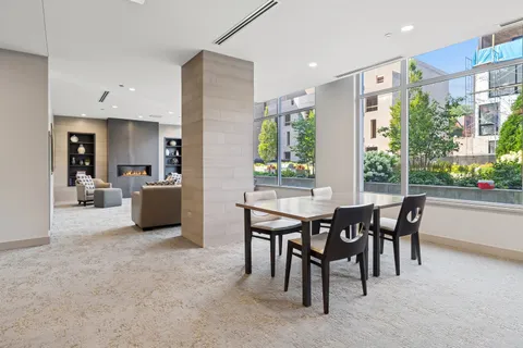a living room with patio furniture and a large window